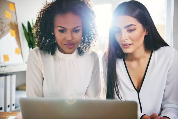 istock Two coworkers working on project with laptop 833130066