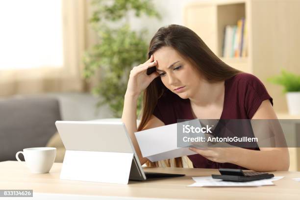 Worried Woman Calculating Accountancy Reading A Letter Stock Photo - Download Image Now