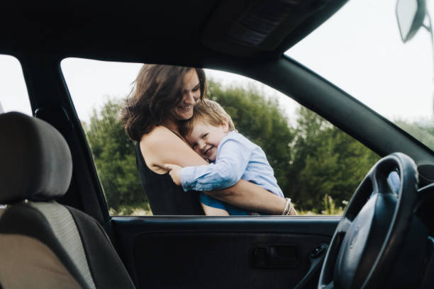 istock Mother with son resting on the meadow  at sunset 833135008