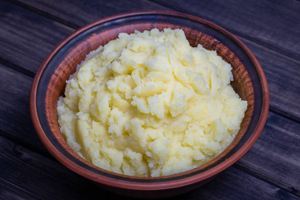 istock Mashed potatoes in a plate on the wooden table 833136922