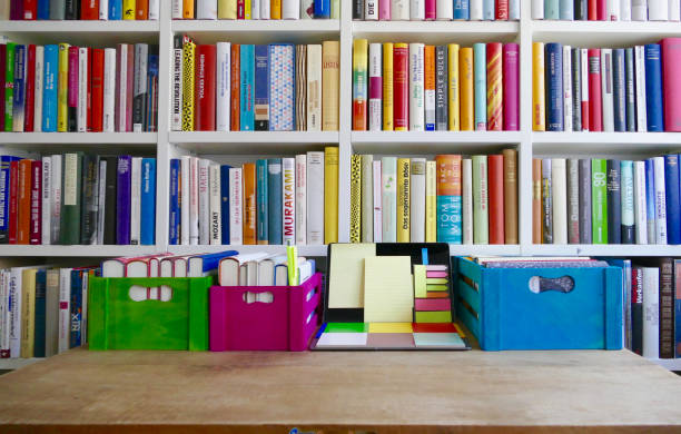 istock Colorful laptop with adhesive notes in front of a book shelf 833137318
