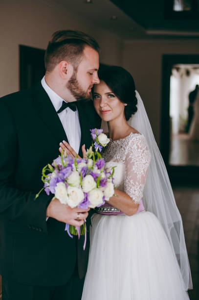 istock Beautiful bride and groom posing at home 833137446