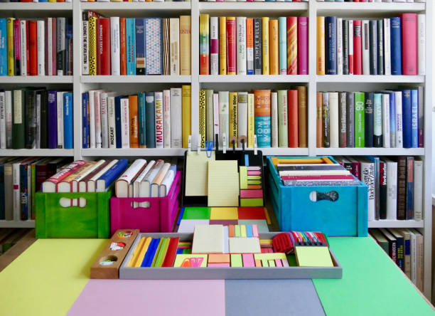 istock Colorful laptop with adhesive notes in front of a book shelf 833139848