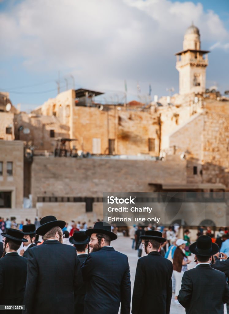 Jews Praying at Western Wall Jerusalem, Israel - October 31st, 2016: Jewsih orthodox belivers walking at the square in front of the Wailing Wall in Jerusalem, Israel. Adult Stock Photo