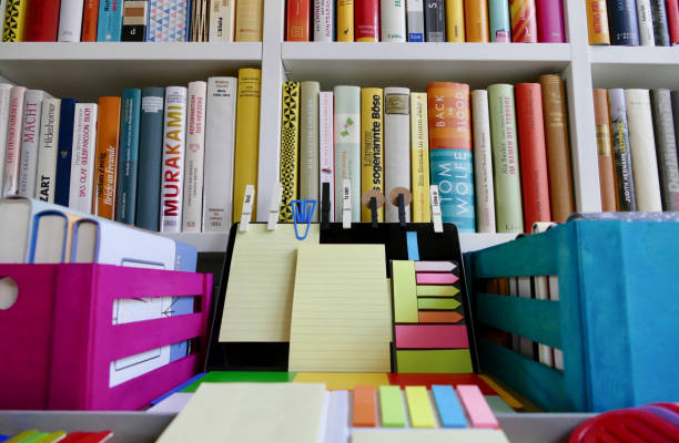 istock Colorful laptop with adhesive notes in front of a book shelf 833142826