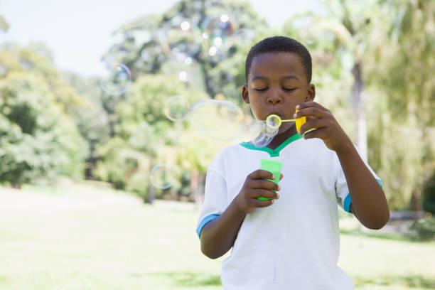 istock Little boy blowing bubbles in the park 833143114