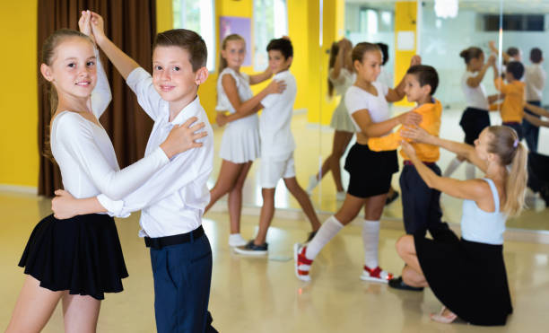 Little boys and girls having dancing class in classroom