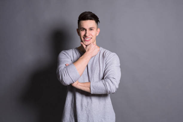 istock Young handsome man portrait at studio grey background 833153978