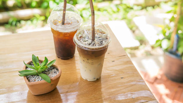 istock iced latte and americano coffee on a wooden table. 833156284