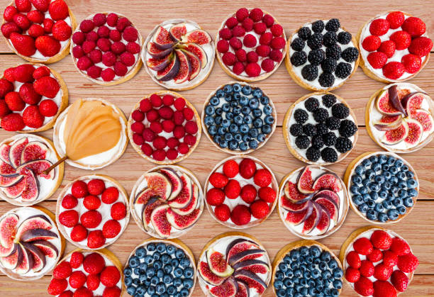 istock Fruit and Berry tarts dessert assorted top view background 833156468