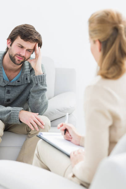 istock Young man in meeting with a psychologist 833162066