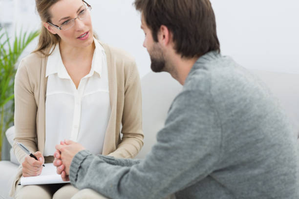 istock Young man in meeting with a psychologist 833169512