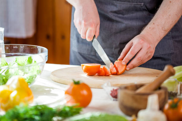 istock Chef cutting fresh and delicious vegetables for salad 833170174