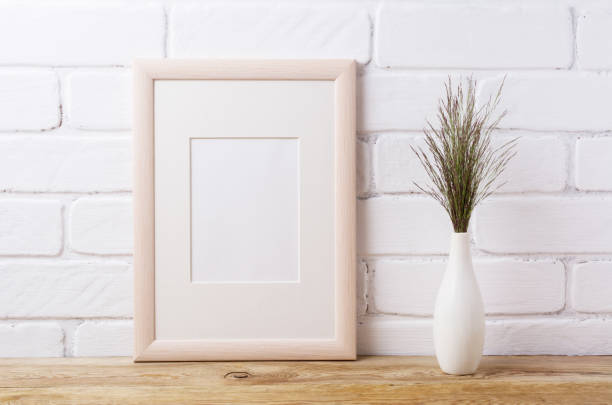 istock Wooden frame mockup with dark grass in elegant vase 833171088