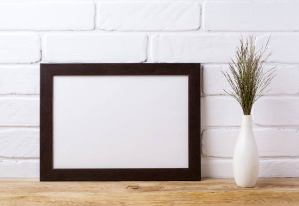 istock Black brown  landscape frame mockup with dark grass in elegant vase 833171182