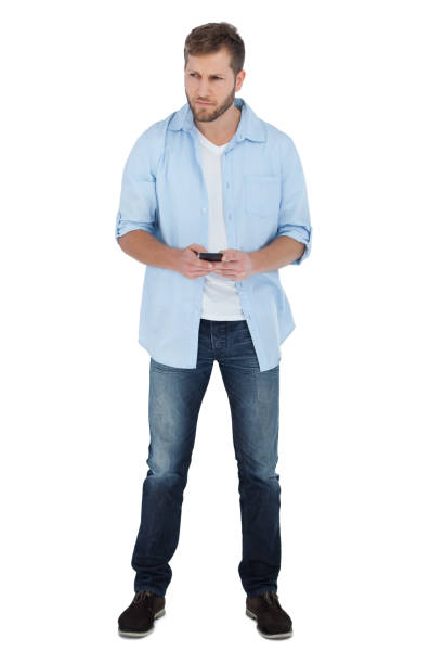 istock Serious man looking away and holding a phone 833171532