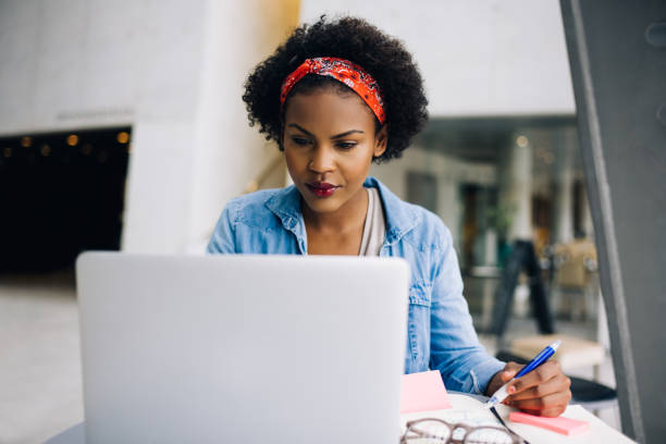 istock Focused young African female entrepreneur working on a laptop 833193742