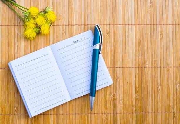 istock Notepad on wood board background. using wallpaper for education, business photo. Take note of the product for book with paper and concept or copy space. 833208030