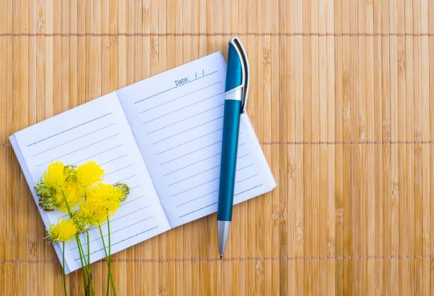 istock Notepad on wood board background. using wallpaper for education, business photo. Take note of the product for book with paper and concept or copy space. 833208084