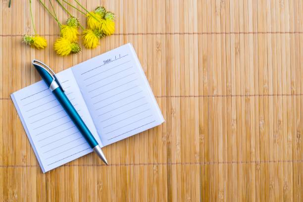 istock Notepad on wood board background. using wallpaper for education, business photo. Take note of the product for book with paper and concept or copy space. 833208128