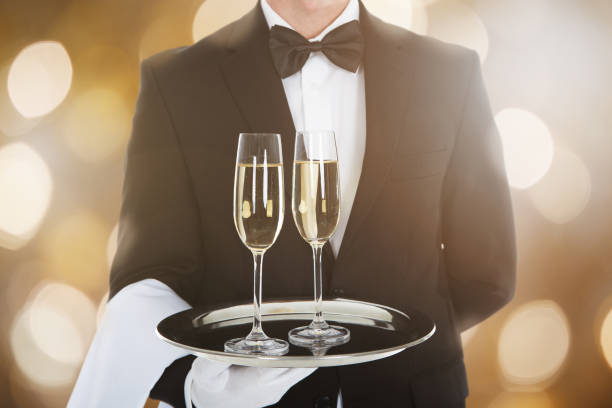 istock Waiter Serving Glass Of Champagne 833211274