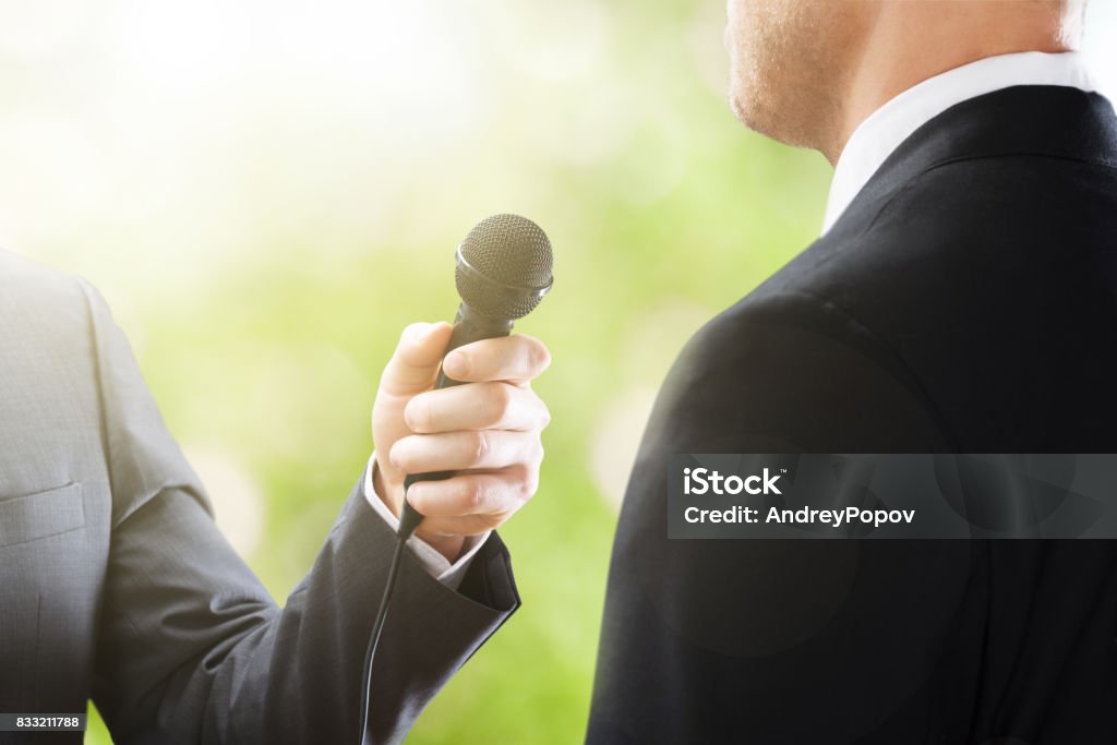 Reporter Conducting Interview Close-up Of A Reporter Conducting Interview Of Businessman Media Interview Stock Photo