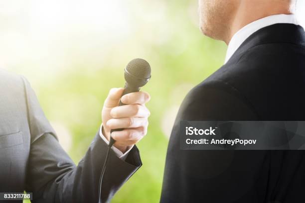 Reporter Conducting Interview Stock Photo - Download Image Now - Media Interview, Adult, Event