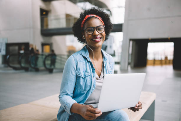 istock Smiling African entrepreneur working online in an office lobby 833212404