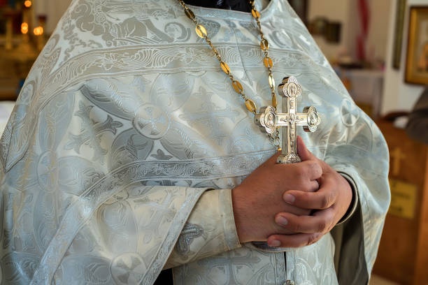 istock Orthodox christian priest holds cross 833220214