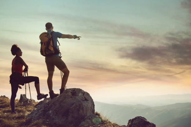 istock Young Couple on Top of Hill Looking at View 833220448