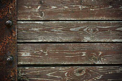 Wooden background from old plank boards with iron fastening, horizontal arrangement in a row