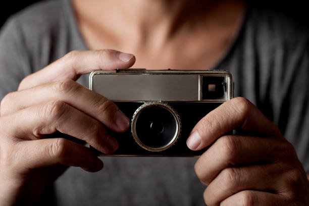 istock young man with a film camera 833226310