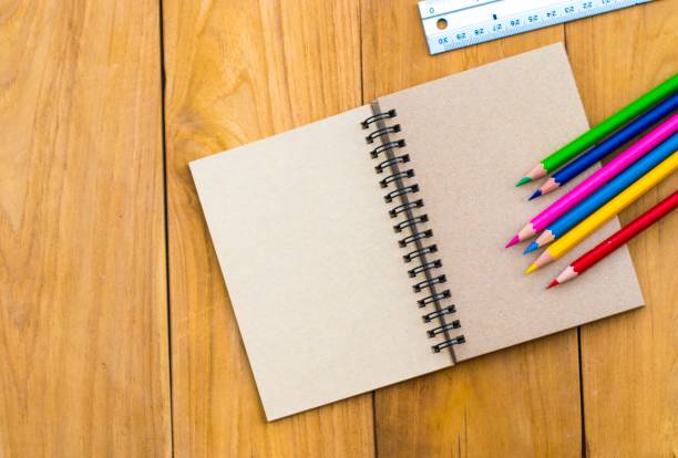 istock Notepad with pencil  on wood board background. using wallpaper or background for education, business photo. Take note of the product for book with paper and concept or copy space. 833226436