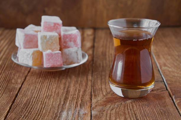 istock Delicious Turkish delight with tea on a wooden background 833226750