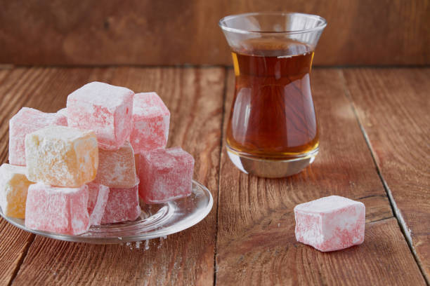 istock Delicious Turkish delight with tea on a wooden background 833226758
