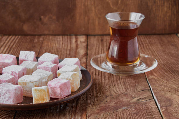 istock Delicious Turkish delight with tea on a wooden background 833226772