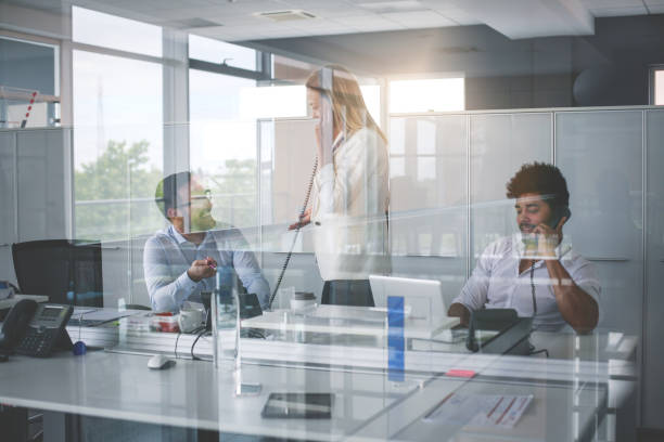 istock People in operations center  talking on Landline phone. Operators in the office. 833226894