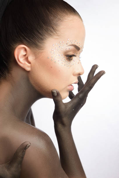 istock Brunette beautiful woman with crystals on face. 833226926
