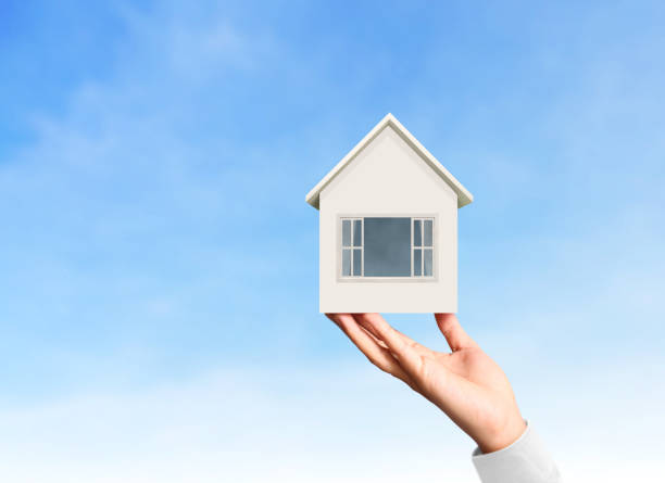 istock Mortgage concept by house from  hand 833236582