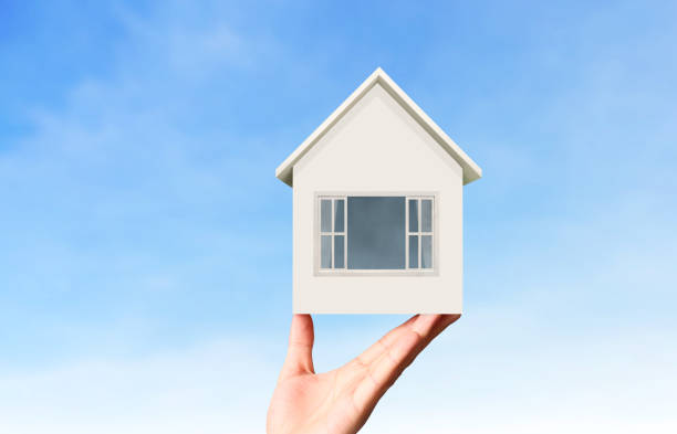istock Mortgage concept by house from  hand 833236592