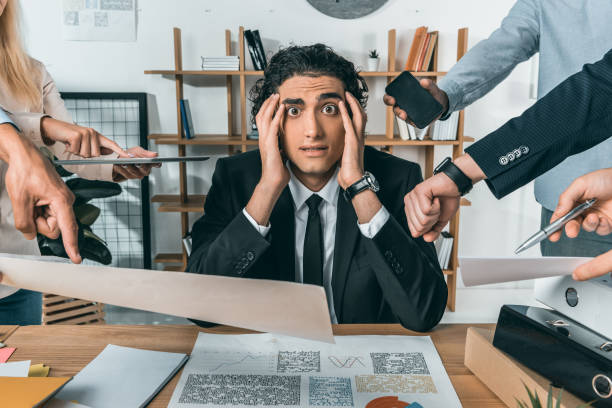 istock overworked businessman missing deadline due to work while colleagues pressing near by 833236836