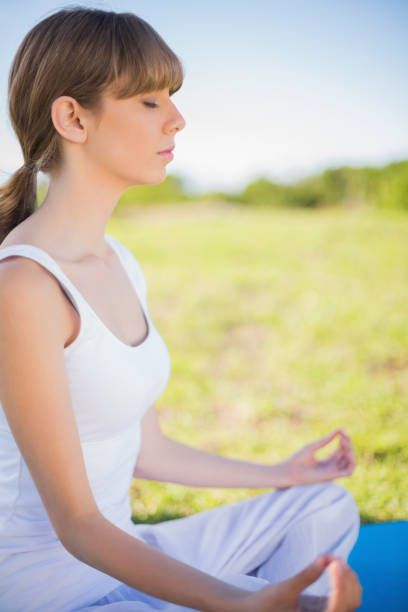 istock Young woman meditating in lotus position 833238228
