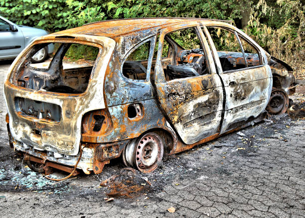 istock Completely burnt-out car on a parking bay 833238978