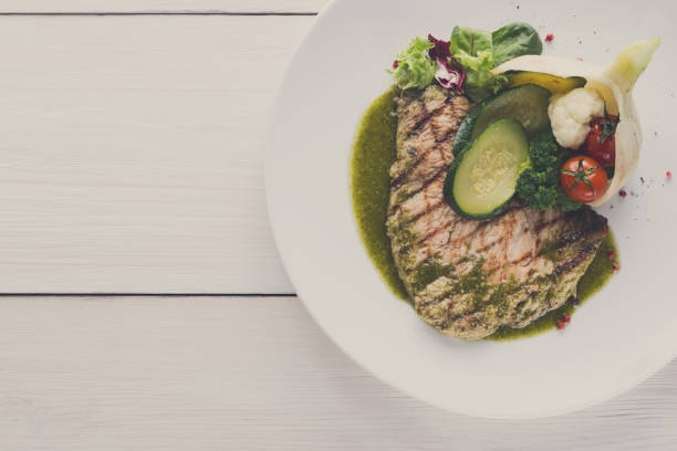 istock Grilled beefsteak with vegetables and green bell pepper sauce 833241036