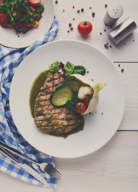 istock Grilled beefsteak with vegetables and green bell pepper sauce 833241110