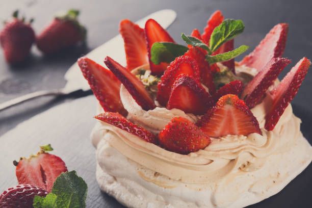 istock Anna Pavlova cake with strawberry on black background 833241818