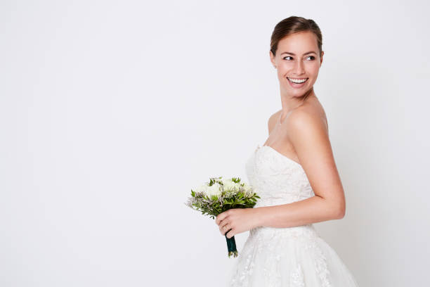 Happy bride Happy bride about to throw bouquet, studio wedding dresses stock pictures, royalty-free photos & images