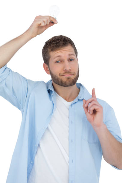 Cheerful model holding light bulb above his head Cheerful model holding light bulb above his head on white background man with a light bulb over his head stock pictures, royalty-free photos & images