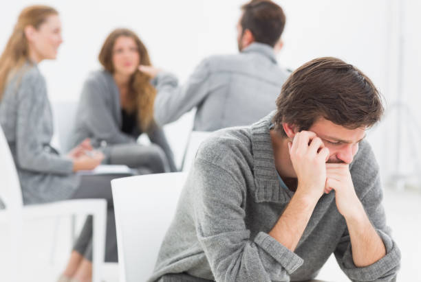 istock Therapy in session sitting in a circle while man in foreground 833247322