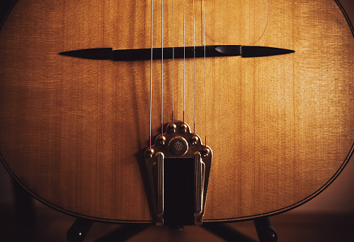 Closeup view of an old manouche acoustic guitar, vintage style.